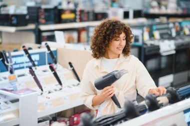 Müşteri saç kurutma makinelerini karşılaştırıyor, perakende mağazasından saç bakım malzemeleri alıyor, satın alma kararı veriyor.