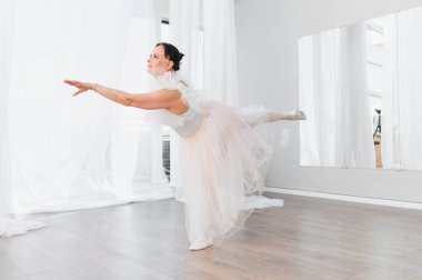 Yaşlı balerin zarif bir şekilde dans eder. Parlak bir stüdyoda. Tutkusunu ve kendini baleye adadığını gösterir.