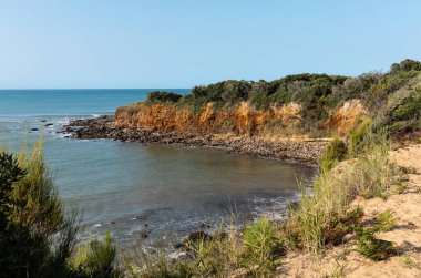 Ochre cliffs of the Cayola point in Les Sables d'Olonne (Vendee - France) clipart