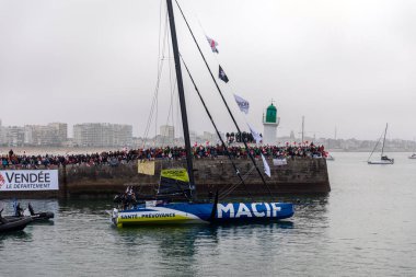 LES SABLES D'OLONNE, FRANCE - NOVEMBER 10, 2024: Charlie Dalin boat (Macif) in the channel for the start of the Vendee Globe 2024 on November 10,2024. in Les Sables d'Olonne, France. clipart