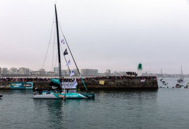 LES SABLES D'OLONNE, FRANCE - NOVEMBER 10, 2024: Sam Goodchild boat (Vulnerable) in the channel for the start of the Vendee Globe 2024 on November 10,2024. in Les Sables d'Olonne, France. clipart