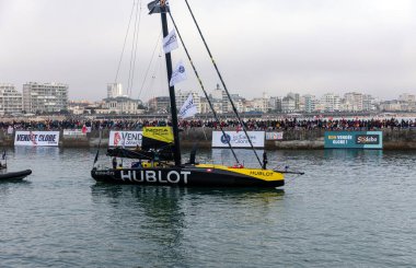 LES SABLES D'OLONNE, FRANCE - NOVEMBER 10, 2024: Alain Roura boat (Hublot) in the channel for the start of the Vendee Globe 2024 on November 10,2024. in Les Sables d'Olonne, France. clipart