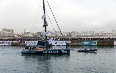 LES SABLES D 'OLONNE, FRANCE - NOVEMBER 10, 2024: Antoine Cornic boat (Human Immobilier) in the channel for the start of the Vendee Globe 2024 on November 10.2024, Les Sables d' Olonne, France.