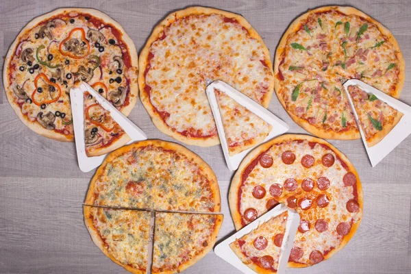 Background Pizza. Set of delicious pizzas with bacon, cheese and mushrooms. Top view