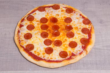 Pizza diavola on white wooden background, italian food