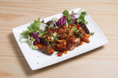 Chilli garlic Mogo Indian street food on white plate