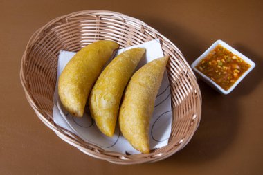 Three colombian empanadas meat pies on white background studio shot from above