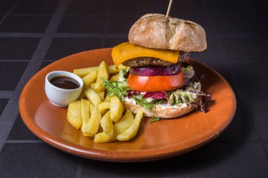 Fresh tasty burger on a plate in restaurant