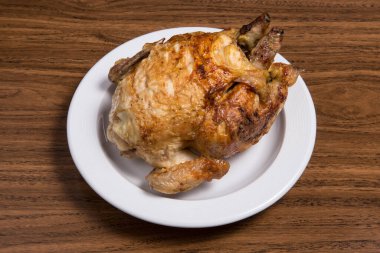 Grilled chicken on a white plate in restaurant