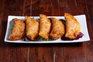colombian empanadas meat pies on wood background studio shot from above