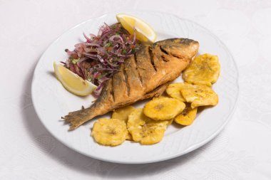 Baked fish called Dorada with banana fries