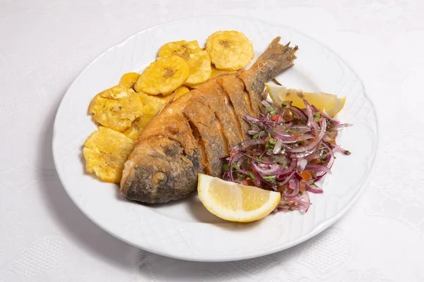 Baked fish called Dorada with banana fries