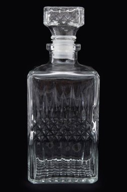 Antique crystal pitcher with glass on black background