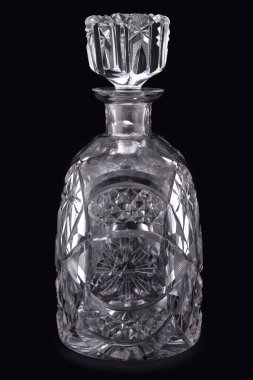 Antique crystal pitcher with glass on black background