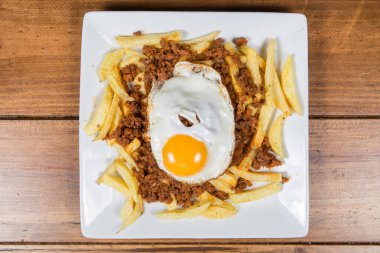 Delicious broken eggs with Jabugo ham and french fries