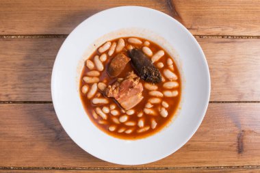 Typical spanish fabada beans whit tomato sauce and sidra