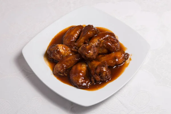Chicken wings marinated in spicy sauce and then barbecued.