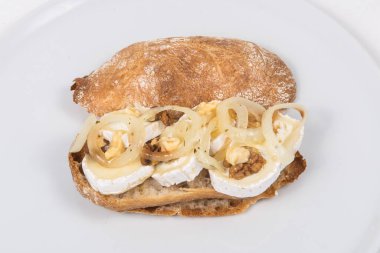 Sandwich with lambs cheese and onion on a white background