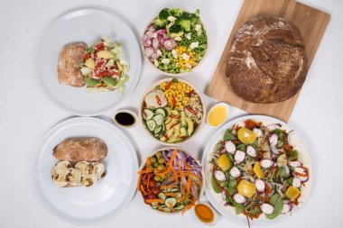 Set of appetizing vegetarian salads and sandwiches 