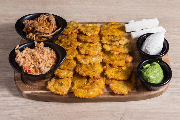 Tostones. Fried banana with shredded meat and cheese
