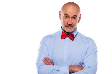 Close-up of mid aged man wearing shirt and bow tie and standing against at isolated white background. Copy space.