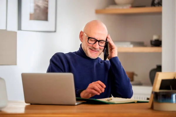Happy Middle Aged Man Making Call Using Laptop While Working — Stok fotoğraf