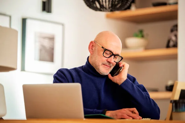 Confident Middle Aged Man Making Call Using Laptop While Working — Stok fotoğraf