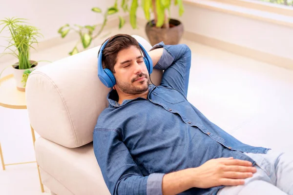 stock image Shot of a handsome young man with headphone using laptop while listening music at home. 