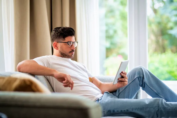 Pria Paruh Baya Yang Duduk Sofa Memegang Tablet Digital Tangannya — Stok Foto