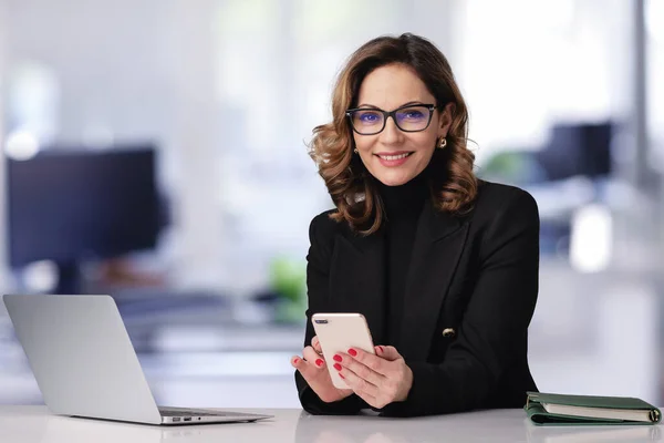 Geschäftsfrau Mittleren Alters Sitzt Büro Und Nutzt Laptop Und Smartphone — Stockfoto