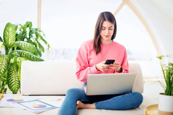 Young Woman Sitting Sofa Home Working Confident Female Using Smartphone Royalty Free Stock Images