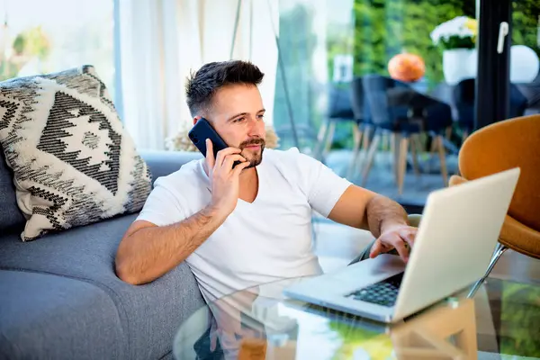 Mid Aged Man Sitting Home Using Laptop Mobile Phone Confident Stock Image