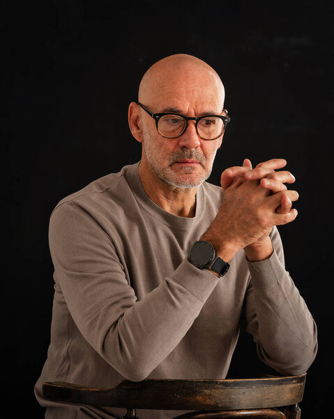 Mid Aged Man Looking Thoughtful Sitting Black Background Bald Stubbled Stock Photo