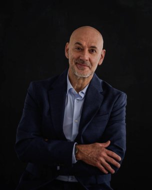 Takım elbise giyen ve izole edilmiş siyah arka plana karşı duran beyaz bir adam. Uzayı kopyala Kıdemli erkek takım elbise ve kravat takıyor ve kameraya gülümsüyor. Boşluğu kopyala. 