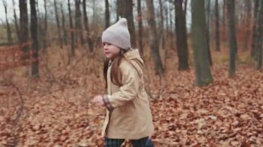 little girl running in the autumn forest