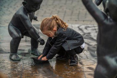 little girl playing in the square