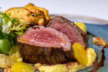 Veal tenderloin, yellow carrot puree, potato muffin, red wine sauce