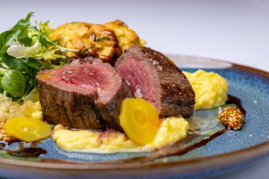 Veal tenderloin, yellow carrot puree, potato muffin, red wine sauce