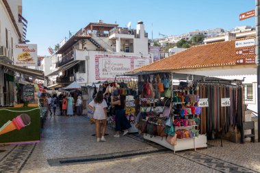 ALBUFEIRA, PORTUGAL - 15th August 2022: Typical shopping narrow streets of the city of Albufeira, Portugal. clipart