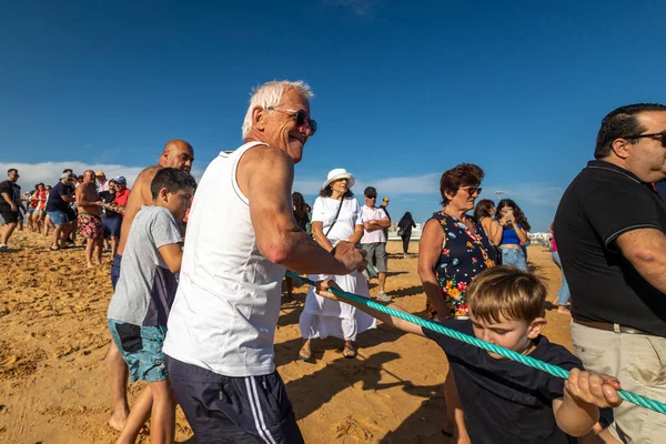 stock image QUARTEIRA, PORTUGAL - 6th JUNE 2023: Cast net fishing tradition done by the local population at beach seashore.