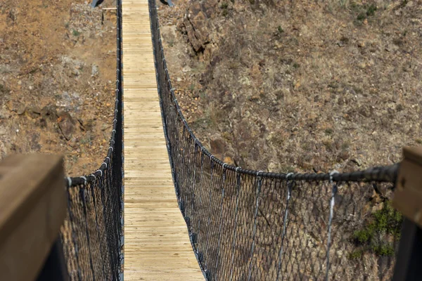 Wooden bridge on nature pathway located near Alferce village, Portugal.