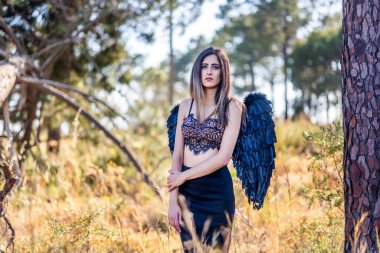 Karanlık kanatlarla poz veren güzel bir kadını yakından görmek, tıpkı bir kara melek gibi..