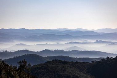 Fog condensation on the mountains of the Monchique region, Alferce, Portugal. clipart