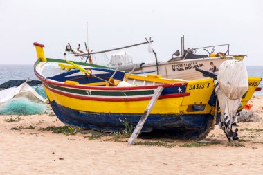 ARMACAO DE PERA, PORTUGAL - 26 Mart 2024: Geleneksel Portekiz balıkçı teknesi Algarve bölgesinde sahile demir attı.