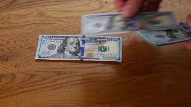 counting a thousand dollars cash money in men hands on the table. . High quality 4k footage