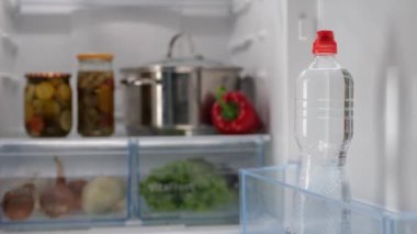 Man Hand, Mutfak Buzdolabının kapısını açar ve bir şişe taze su alır. Yüksek kalite 4k görüntü