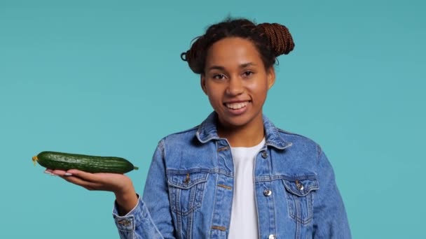 African Girl Holds Fresh Cucumber Her Hands Smiles Studio Shot — Stock Video