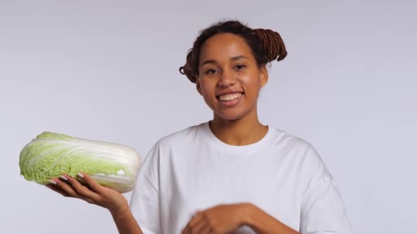 African Girl Holds Chinese Cabbage Her Hands Smiles Studio Shot — Stock Video