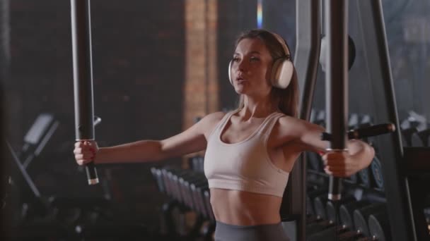 Spor Salonunda Kulaklık Takarken Metal Makine Kullanan Kalçalarına Beline Karnına — Stok video