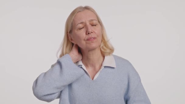 Woman Blue Sweater Holding Her Neck Because She Has Sore — Stock Video
